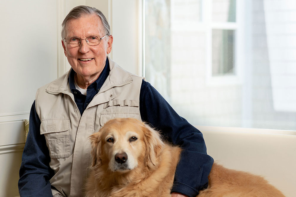 Senior man posing with his dog